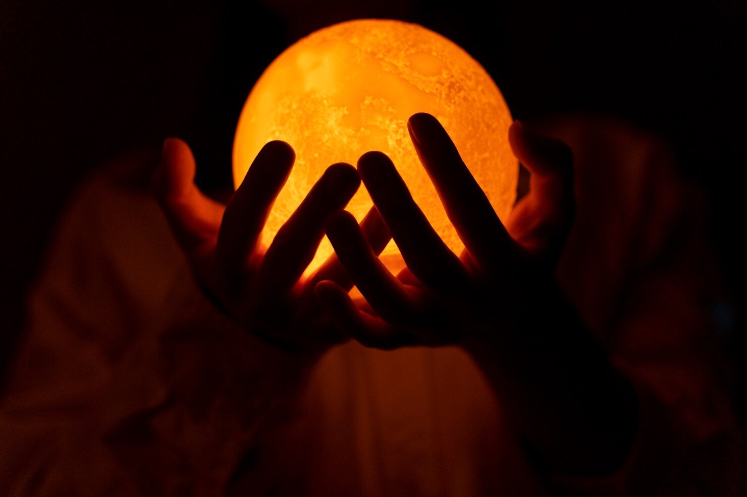 view-hands-holding-moon-light_23-2150571080